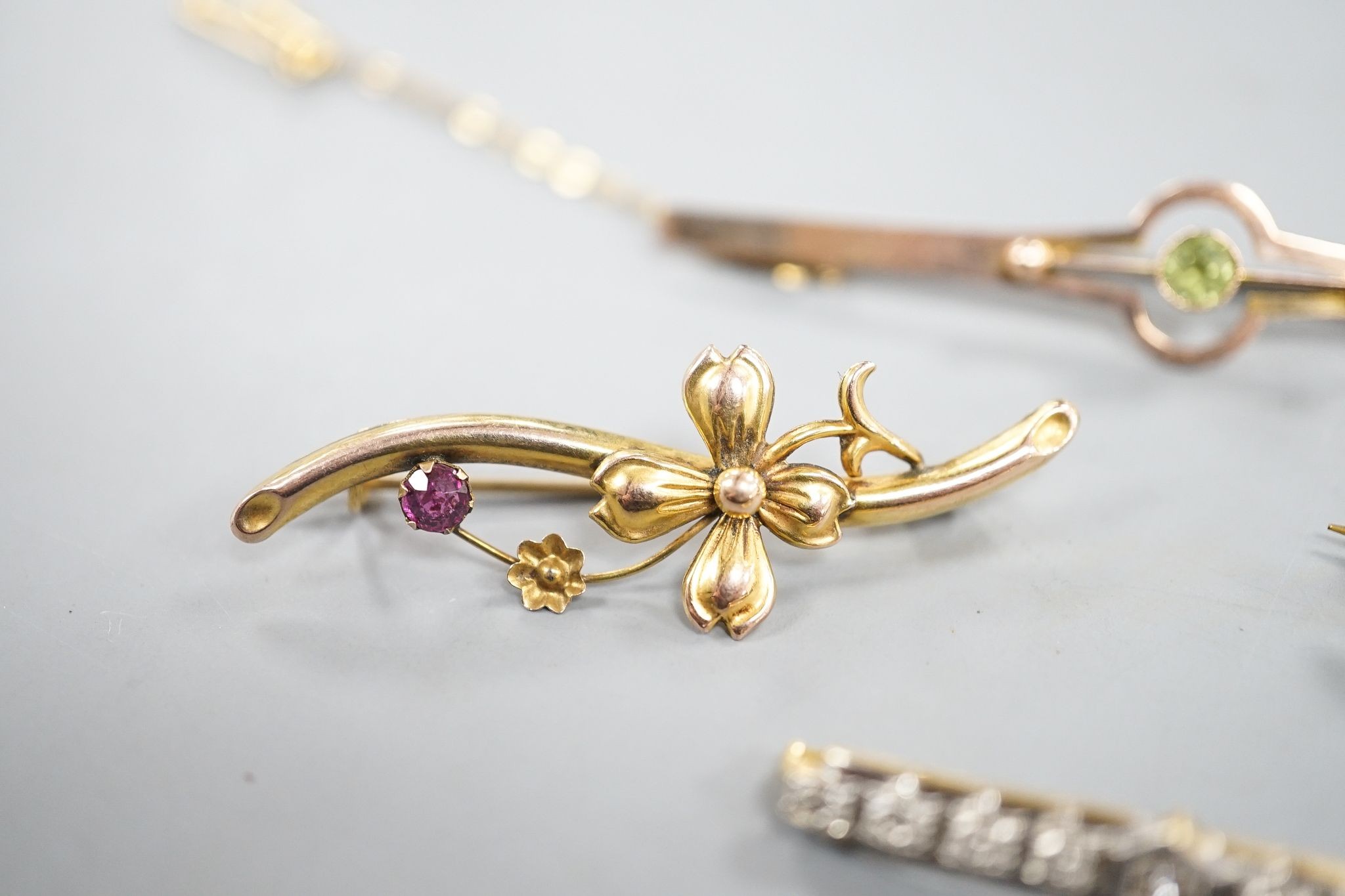 Three assorted 9ct and gem set bar brooches, including a swallow brooch, gross 5.9 grams and one other yellow metal and diamond chip set bar brooch, gross 1.7 grams.